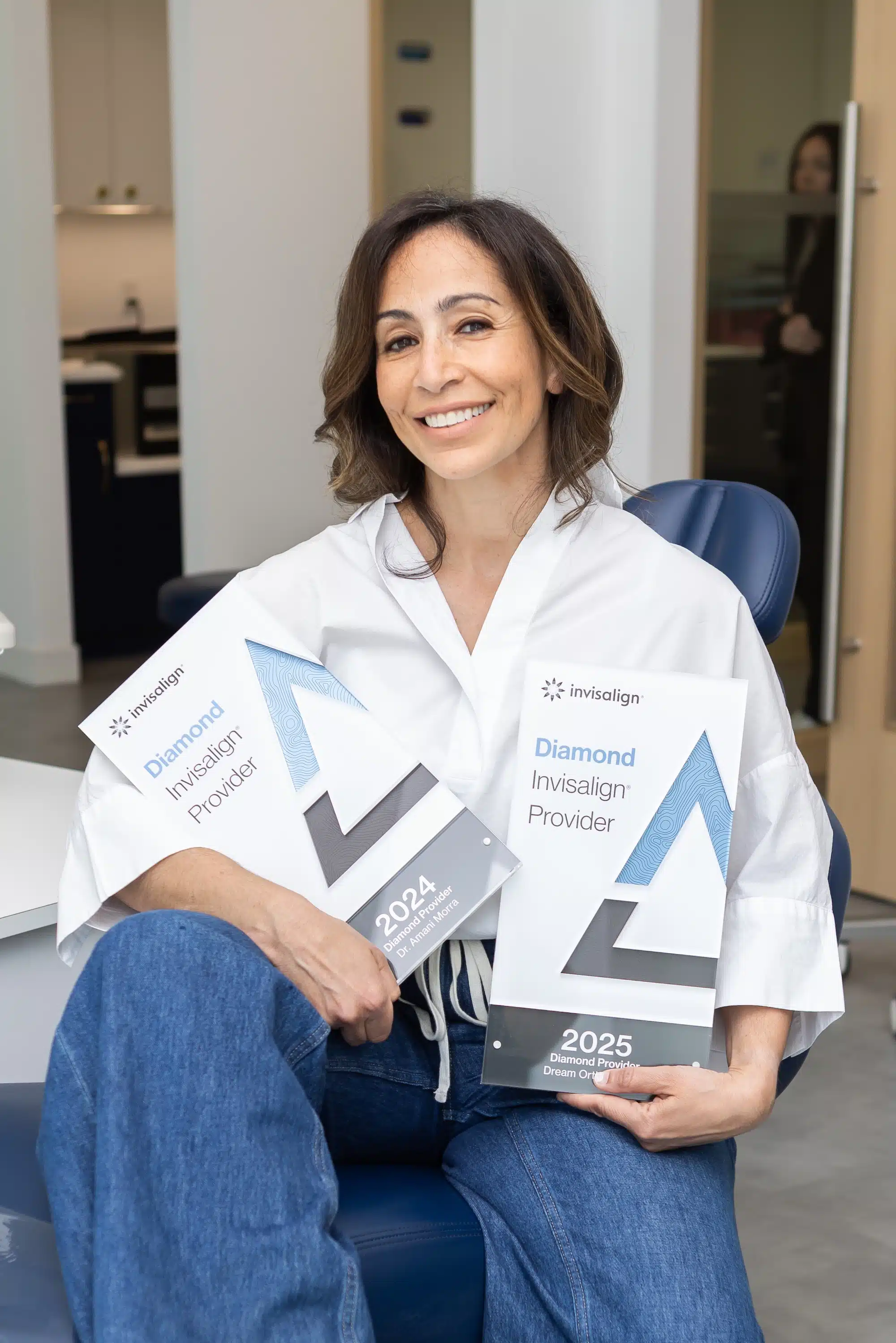 Dr. Morra holding Invisalign diamond status