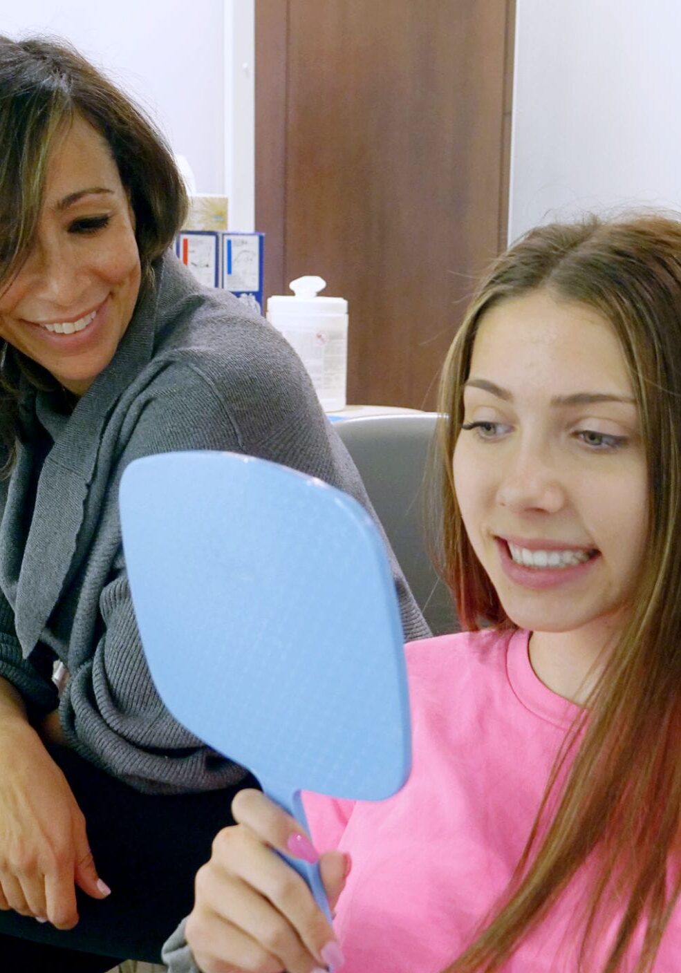 Dr. Morra sitting with a patient