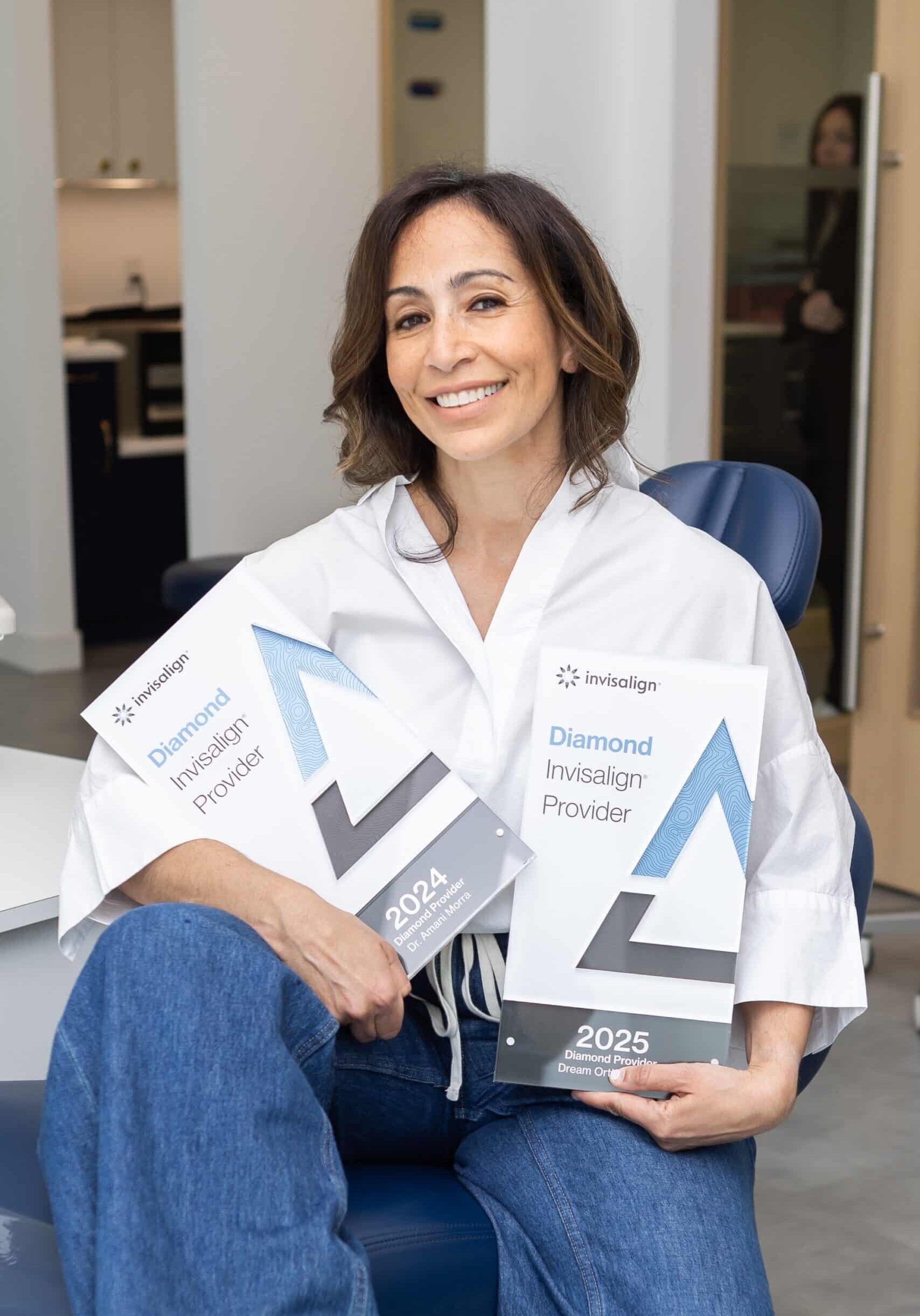 Dr. Morra holding Invisalign diamond status